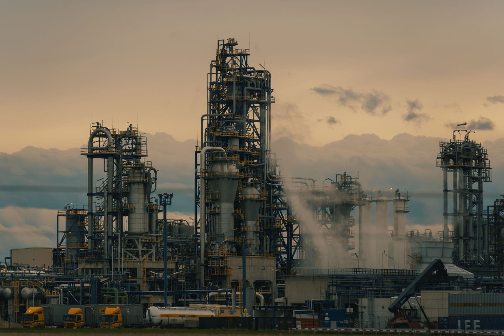 Refinery towers at dusk representing petroleum supply operations